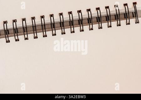 Minimalist spiral notebook with blank pages and metal binding. Clean and elegant background for business, education, stationery designs Stock Photo