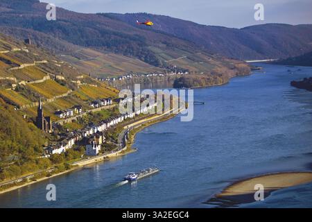 Elevated view over the Rhine from Bacharach and Lorch with the parish church of St. Martin, with barge and helicopter, UNESCO World Heritage Upper Mid Stock Photo
