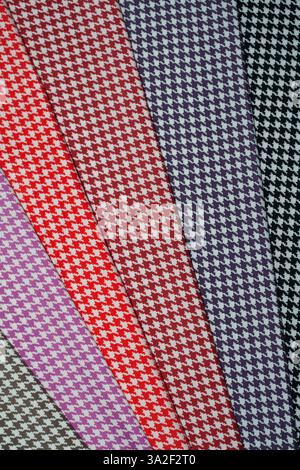 Multi-colored fabric patterns with geometric pattern for sewing, showcase the variety of colors and styles in the textile collection. Stock Photo