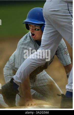 Del Campo's Miles Morissette yells back toward the umpire telling him he wasn't tagged, as he was picked off first base in a playoff game against Christian Brothers. Miles is wearing the number 4 under his eyes in tribute to Jame Hurst. James Hurst was a key member of the 2003 Del Campo baseball team last year. On tuesday night James Hurst was struck by a car while standing in his front yard. He passed away Wednesday night around midnight. In his honor players and fans wore his number. Del Campo lost the playoff game to Christian Brothers. Picture taken at Sacramento City College Union Stadium Stock Photo