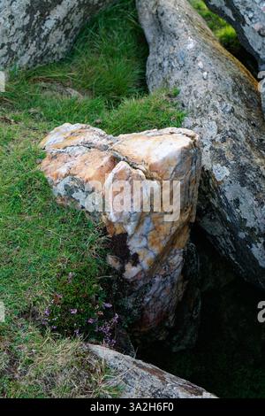 Rose quartz block inside Moorneen megalithic chambered tomb burial chamber dolmen also known as Muirnin. 1km south of Cleggan, Connemara, Ireland Stock Photo