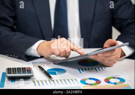 Businessman Analyzing Financial Charts and Stock Market Data Stock Photo