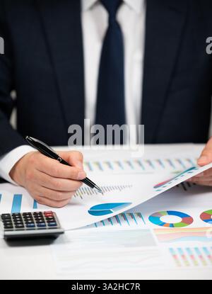 Businessman Analyzing Financial Charts and Stock Market Data Stock Photo