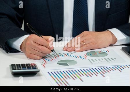 Businessman Analyzing Financial Charts and Stock Market Data Stock Photo