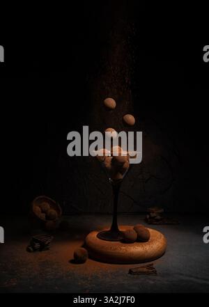 levitation of sweets in a glass on a dark background with cocoa and chocolate Stock Photo
