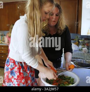 May 19, 2014 - Everett, WA, USA - Charity Edwards, from right, and her youngest daughter Ellie Edwards, 6, second right, prepare a salad for dinner on Monday, May 19, 2014, in Everett, Wash.  Sen. Patty Murray (D-WA) proposed legislation Wednesday, May 21, 2014, to give poor families $150 per child to spend on food during the summer months. (Credit Image: © Kevin Fujii/MCT/ZUMAPRESS.com) Stock Photo