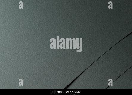 Dark green paper background with a rough, organic texture and perforated details. Deep, natural tones create an elegant, luxury design, ideal for prem Stock Photo