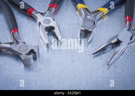 Set of electric metal wire cutters on scratched metallic background Stock Photo