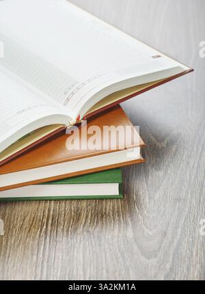 Three notebooks on wooden background Stock Photo