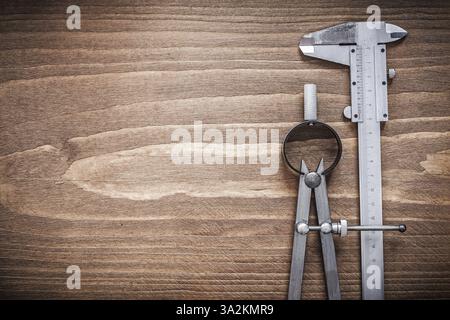 Slide caliper divider on wooden board copyspace construction concept Stock Photo
