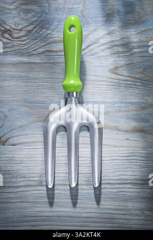 Stainless trowel fork on wooden board top view gardening concept Stock Photo