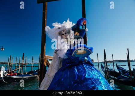 Venetian Masks in red costumes in Venice Italy Stock Photo - Alamy