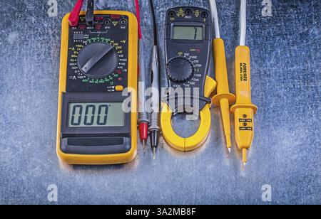Set of digital clamp meter electric tester multimeter on metallic background electricity concept Stock Photo