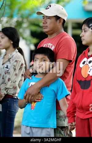 June 23, 2014 - Hudson, Florida, U.S. - Jorge Cruz holds his son, David Cruz Pallares, during a press conference outside Regional Medical Center Bayonet Point as the family's attorney gives an update on the health condition of his wife, Anita Pallares and surviving son David.  John Ryals, 21, of Land O'Lakes, was driving a white chevrolet van when he struck and killed Jorge Cruz, 9, and seriously injured his brother David Cruz, 7, and mother, Anita Pallares, 33, while the family was out walking with their dog around 7:45 a.m. on Bahia Loop in Land O'Lakes Wednesday June 18. The dog was killed Stock Photo
