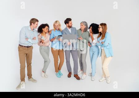 Group of diverse professionals collaborating on a project in an office setting with a modern, stylish atmosphere and engaging teamwork Stock Photo