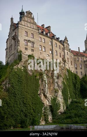 Majestic Sigmaringen Castle Perched on Rugged Cliff Above Tranquil Danube: Historic Hohenzollern Residence Showcases Medieval Architecture and Royal Stock Photo