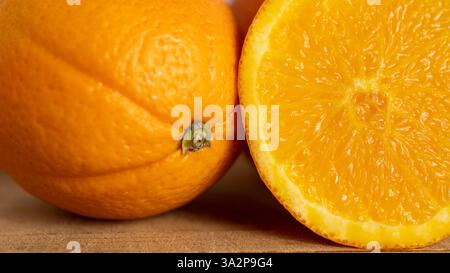 A close-up shot of a vibrant orange, showcasing its textured peel and juicy interior. The image captures the freshness and natural beauty of the citru Stock Photo