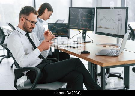 Focused on a project. Two employees are working in the office together. Stock Photo