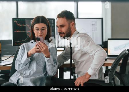 Two employees are working in the office together. Stock Photo