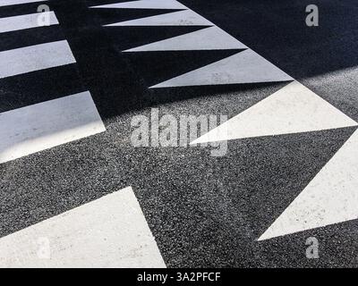 Abstract pattern created by pedestrian crossing markings on city street - Tours, Indre-et-Loire (37), France. Stock Photo