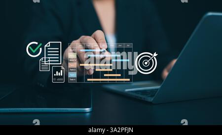 Project management tool and work schedule concept, Planning software, Businessman use laptop to manager working projects and update task with gantt ch Stock Photo
