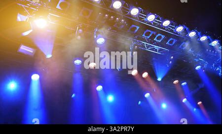 glowing blue ceiling spotlights working during the show Stock Photo