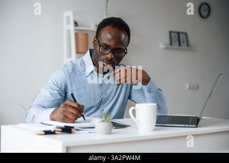Manager is using laptop. Businessman is working in the office. Stock Photo
