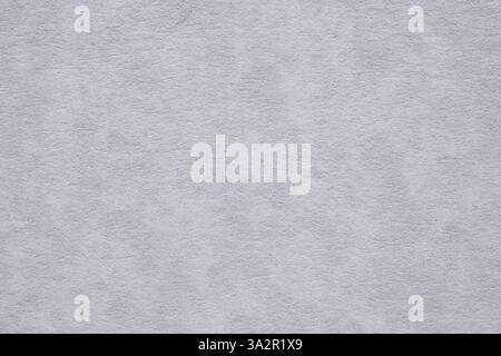 Macro detail texture of a grayish white paper with a marbled effect in soft light, perfect for backgrounds and graphic design. Stock Photo