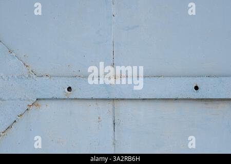 Old blue metal texture with rivets and holes. Abstract background Stock Photo