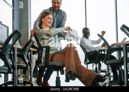 Having fun, break time, wellness. Team of office workers are together indoors. Stock Photo