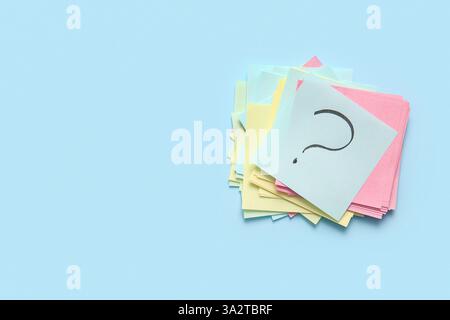 Heap of different sticky notes with question mark on color background Stock Photo