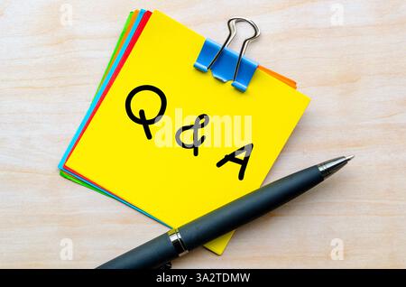 Q and A text on yellow notepad. Question and Answer concept. Stock Photo