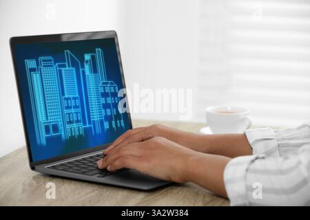 Building information modeling. Woman working at laptop indoors, closeup. Digital project on computer display Stock Photo