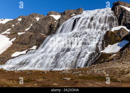 Dynjandi (Fjallfoss) waterfall in Westfjords, Iceland with volcanic rocks and stony footpath, long exposure. Stock Photo