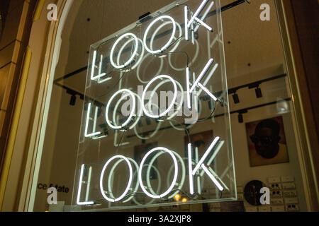 Look Look Look neon letters behind the window in a optician store. Stock Photo