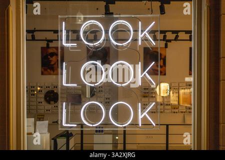 Look Look Look neon letters behind the window in a optician store. Stock Photo