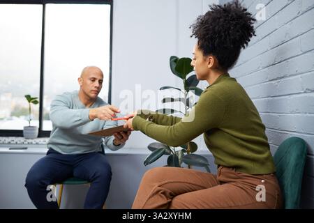Professional Consultation Between Two Individuals in a Modern Office Setting Stock Photo