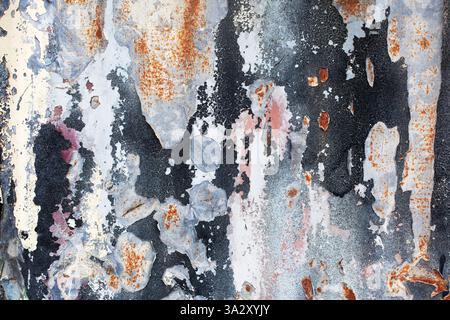 Paint peeling from a rusty old metal fence Stock Photo