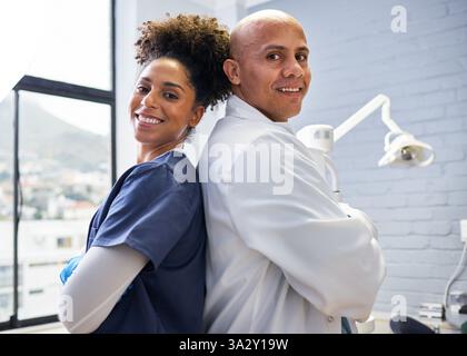 Professional Dental Team Posing Confidently in Clinic Setting Stock Photo