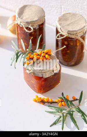 A collection of jars filled with golden seabuckthorn and apple jam Stock Photo