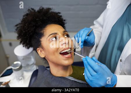 Female Patient Smiling During a Dental Checkup in a Modern Clinic Stock Photo