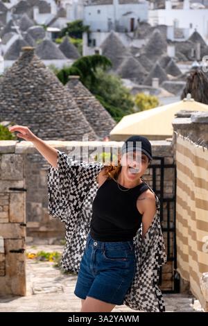 White woman smiling and happy in Alberobello, Italy Stock Photo