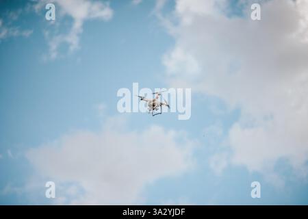 A Drone Hovering in a Blue Sky Stock Photo