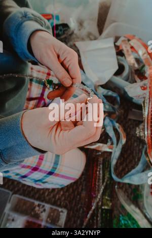 Woman making a beaded holiday craft Stock Photo