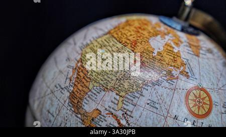 Table world  Globe model in blue and brown color isolated on black background. Stock Photo