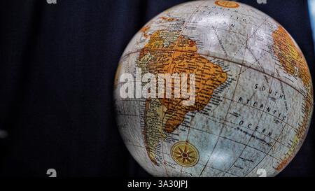 Table world  Globe model in blue and brown color isolated on black background. Stock Photo
