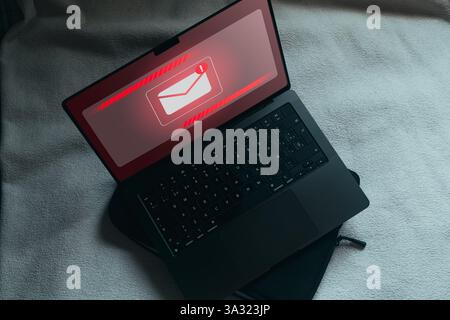 Spam email concept on laptop screen. Internet security. Spam, junk and e-marketing. Email Pop up Warning. Stock Photo