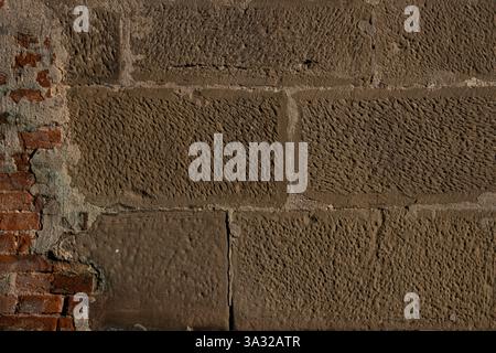 Weathered brick and sandstone wall with distinct textures, showcasing historical and rugged aesthetics, ideal for backgrounds. Stock Photo