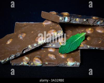 Chocolate and nut bars with a mint leaf Stock Photo