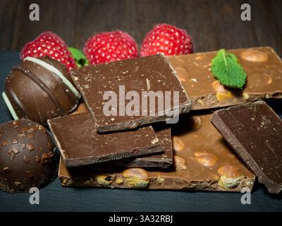 Chocolate, raspberries, bonbon with a mint leaf  (bonbon) Stock Photo